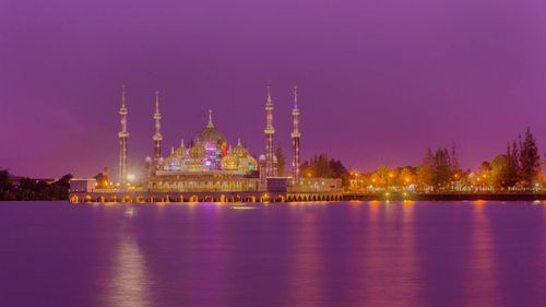 River with mosque against clear sky