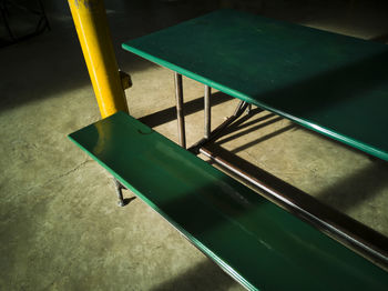 High angle view of empty chairs by swimming pool