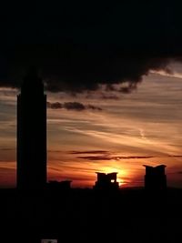 Silhouette of built structure at sunset