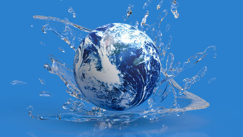 Close-up of crystal ball against blue background
