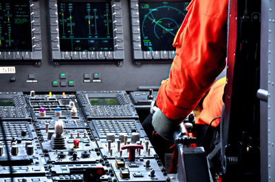 Cropped image of pilot sitting on helicopter cockpit