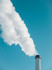 Low angle view of smoke stack against sky