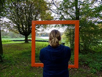 Rear view of woman standing on field