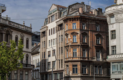 Low angle view of buildings in town against sky