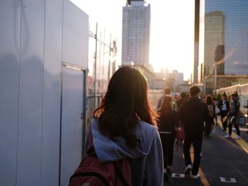 Rear view of people on modern building in city