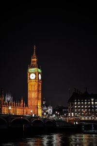 Illuminated clock tower at night