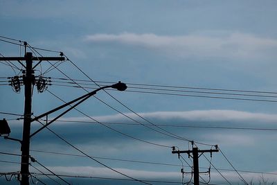 Low angle view of electricity pylon against sky