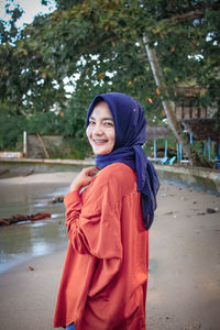 Portrait of smiling man standing on shore