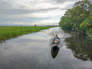 Man on boat against sky