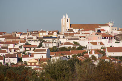 Houses in town against clear sky