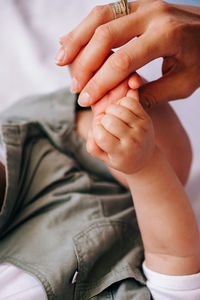 Low section of woman holding hands