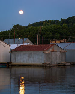 Scenic view of lake against sky at night