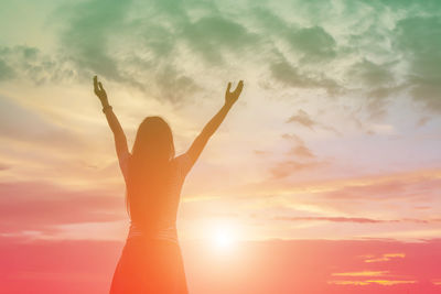 Silhouette woman standing by tree against sky during sunset