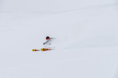 Man skiing on snow covered landscape