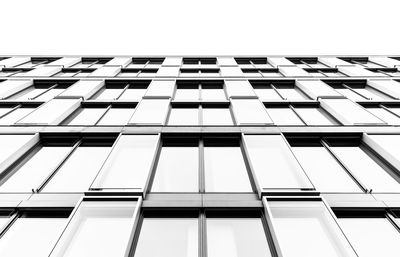 Low angle view of glass building against sky