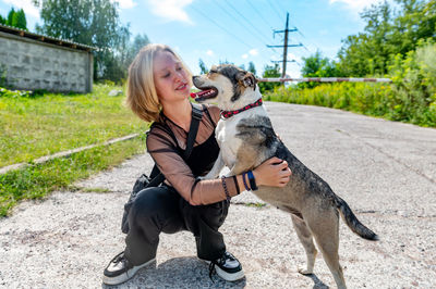 Low section of man with dogs on field