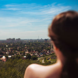 Rear view of man with cityscape in background