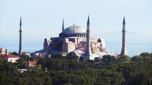 Panoramic view of buildings and city against sky