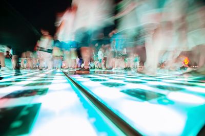 Blurred motion of people walking on street