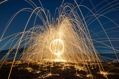 Close-up of illuminated lighting against sky at night