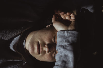 High angle view of sad woman with closed eyes at home