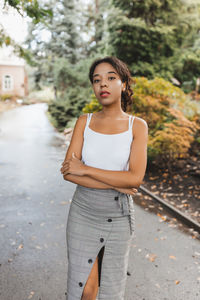 Young woman standing on road