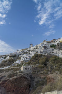 Houses in town against blue sky