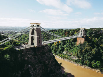 Bridge over river against cloudy sky