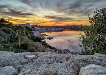 Scenic view of lake against sky during sunset