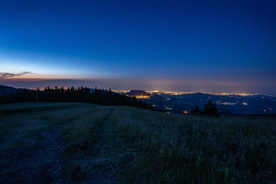 Scenic view of landscape against blue sky at night