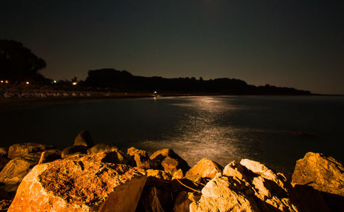 Scenic view of sea against clear sky at night