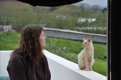 Woman and ginger cat at home