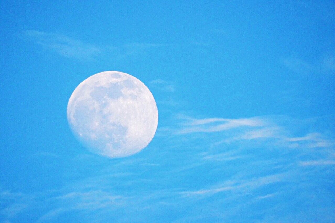 blue, low angle view, sky, moon, sphere, beauty in nature, circle, tranquility, nature, scenics, planetary moon, astronomy, tranquil scene, full moon, cloud - sky, discovery, moon surface, cloud, outdoors, sky only