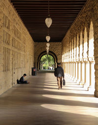 Woman walking in corridor of building