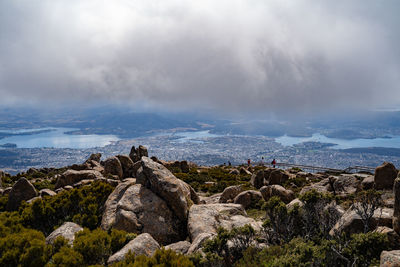 Rocks by sea against sky