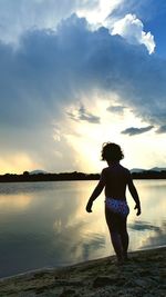 Rear view of man standing on beach