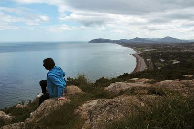 Rear view of man looking at sea