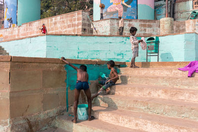 People on staircase against wall