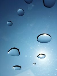 Full frame shot of water drops against blue background