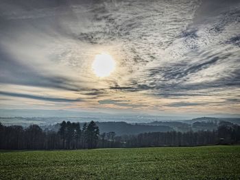 Scenic view of field against sky during sunset