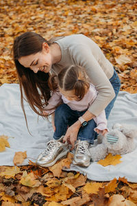 Dressing child for autumn fall outdoor play. autumn fashion for baby toddler, kids. autumn outdoor