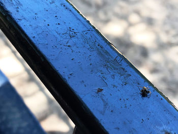 Close-up of rusty metal against blue sky