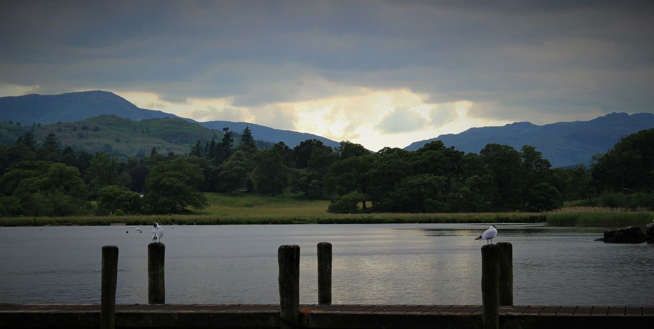 water, mountain, tranquil scene, sky, tranquility, scenics, lake, tree, beauty in nature, nature, mountain range, cloud - sky, cloud, idyllic, non-urban scene, river, lakeshore, landscape, outdoors, pier