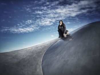 Low angle view of woman against sky