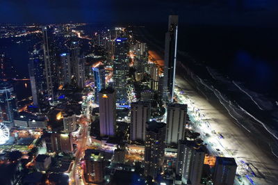 Aerial view of city lit up at night