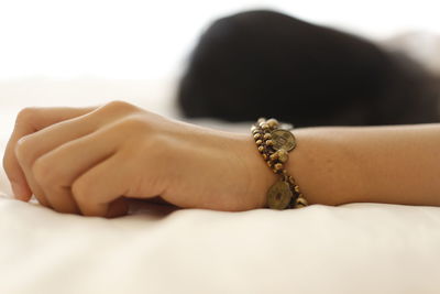 Close-up of woman hand over white background