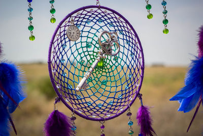 Close-up of dreamcatcher hanging outdoors