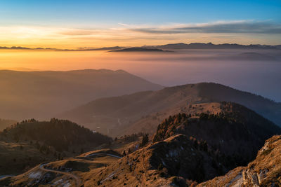 Scenic view of mountains against sky during sunset