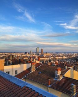 Cityscape against cloudy sky