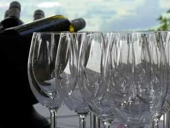 Close-up of wine glasses hanging in water